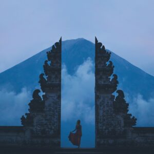 woman in between on concrete landmarks near white clouds